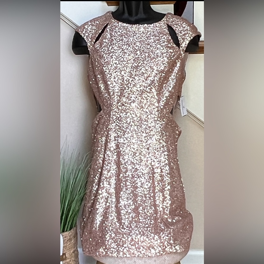 WINDSOR: Gold, sequined mini dress with cut out shoulders and sides.